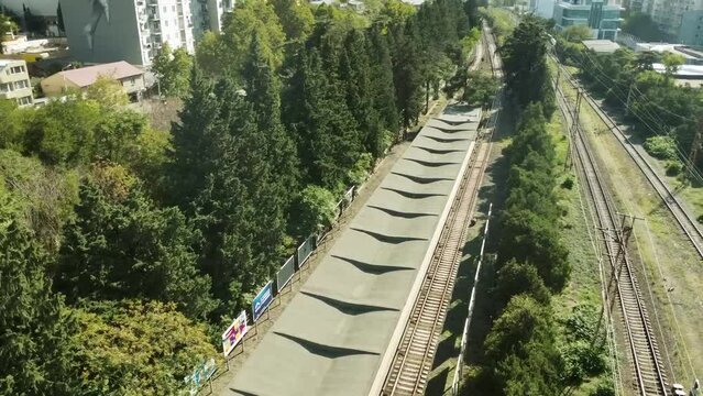 Drone view: Zugdidi Railway Station in Georgia, capturing its unique structure and scenic backdrop.