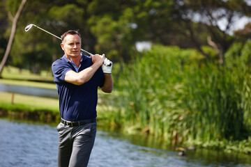 Man, swing and golfer with club by lake for point, score or par shot in outdoor nature. Male person...