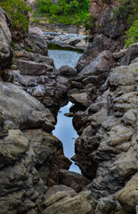 Crystal clear waters reflecting the vibrant sky and rocks.