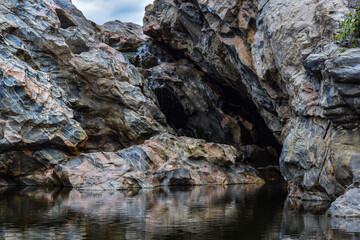 Crystal clear waters reflecting the vibrant sky and rocks.