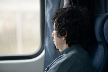 Serene Senior Woman Reflecting by Train Window