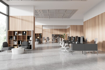 Modern office interior with desks, chairs, computers, and bookshelves, on a concrete floor and wooden panel background, concept of workplace. 3D Rendering