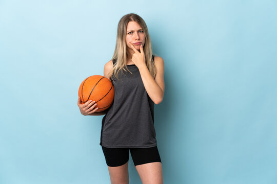 Young blonde woman playing basketball isolated on blue background thinking an idea