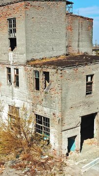 Abandoned ruined industrial factory building, ruins and demolition concept. Aerial view Vertical video