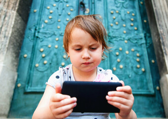 Social Media addiction. Portrait of little child girl with phone (psychological problems, media mania, education) - 790641622