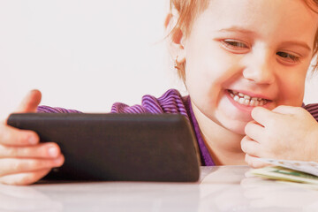 Portrait of happy baby girl with smart phone. - 790641627