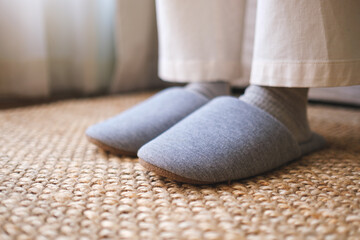 Closeup of a woman wearing slippers at home