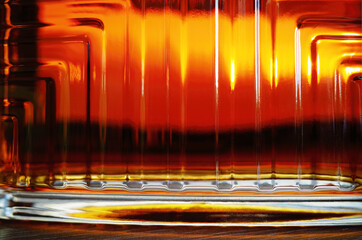 Rich glass texture of luxury cognac bottle in detail backdrop