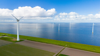 A wind farm filled with turbines rises from the choppy waters of the Netherlands, harnessing the...