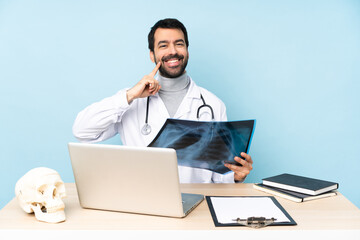 Professional traumatologist in workplace smiling with a happy and pleasant expression