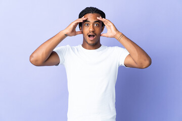 Young African American man with braids man isolated on purple background with surprise expression
