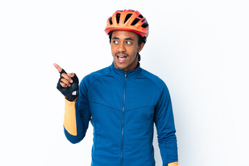 Young cyclist man with braids over isolated background intending to realizes the solution while lifting a finger up - obrazy, fototapety, plakaty