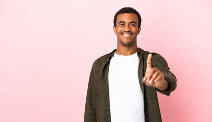 African American man on copyspace pink background showing and lifting a finger