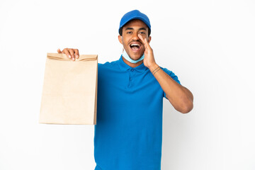 African American man taking a bag of takeaway food isolated on white background shouting with mouth...