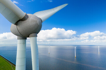 A single wind turbine standing tall in the middle of a large body of water, harnessing energy from...