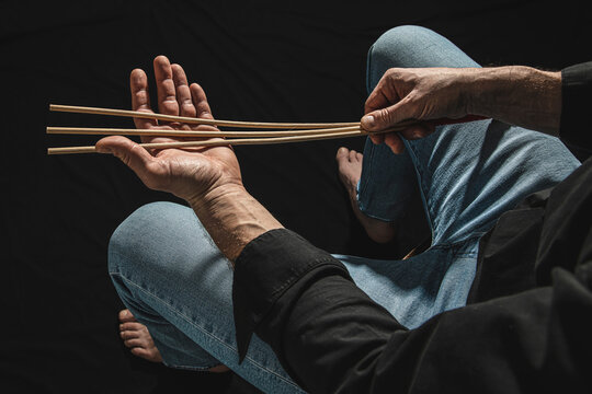 Strict man with rattan cane.