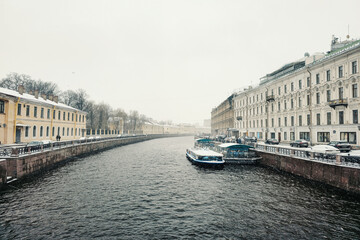 pleasure boat is moored on the river in a spring snowstorm