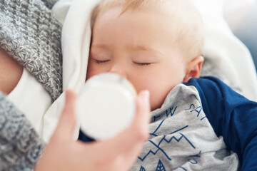 Mother, baby and feeding with maternity, home and love for child development and milk bottle. Mom,...