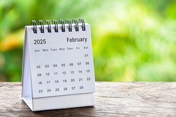 February 2025 white table calendar with customizable space for text. Calendar concept and copy space
