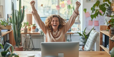 One mixed-race Afro-haired African American entrepreneur savoring a workplace success. Hispanic woman utilizing a desktop successfully. Happy woman shouting yes