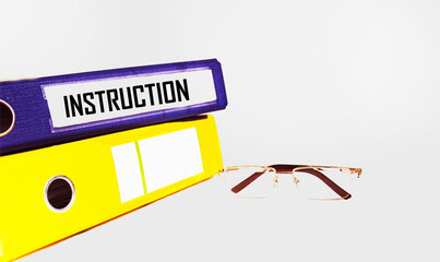INSTRUCTIONS The word is written on a document folder with glasses on a white background. Business...