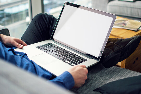 Computer mockup image blank screen with white background for advertising, with hand using laptop contact business search information on desk at coffee shop