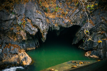 Cave on the river in the mountains. Beautiful natural background.