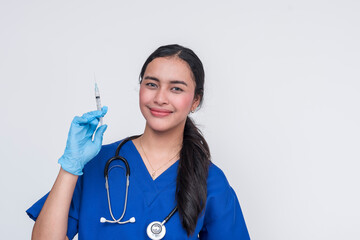Young Asian female nurse in blue scrubs holding a syringe, isolated on white