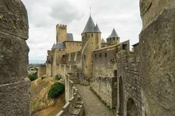 Fototapeta na wymiar Carcassone castle with ramparts and towers on sunny day, popular tourist landmark in France