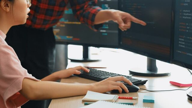 Slow motion back end or software developer manager supervising his team on new application program development on debugging and solving complex code algorithms on monitor. Burgeoning