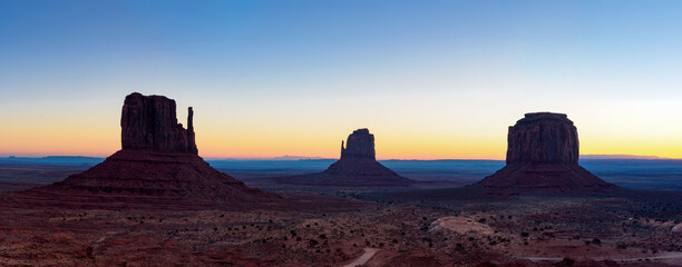 View of three iconic rocks; West Mitten Butte, East Mitten Butte, and Merrick Butte at sunrise,...