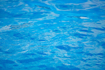 Swimming pool bottom caustics ripple and flow with waves background. Summer background. Texture of water surface. Overhead view. - 790689251