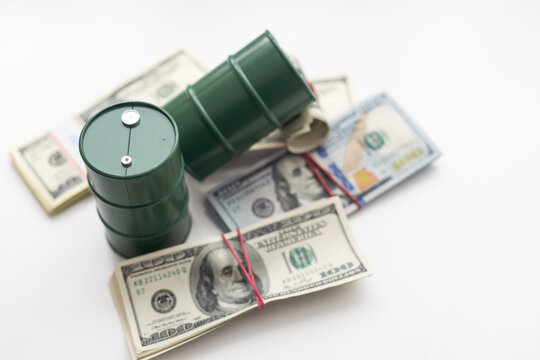 barrels of oil standing on the dollar bills of money. the oil business, purchase sale, production, exchange, trading income.