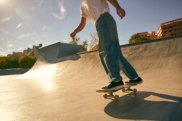 Close up of young skateboarder flies with his board on the ramp of a skate park
