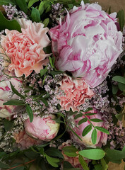 Bouquet of lush flowers in pink and crimson shades
