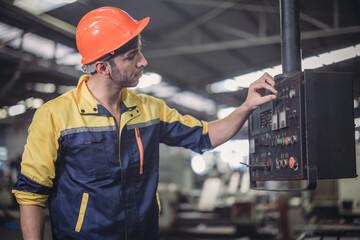 Technician adjusts and troubleshoots factory machinery for optimal performance and safety standard