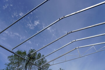 Installation of metal structures using a crane
  against the blue sky