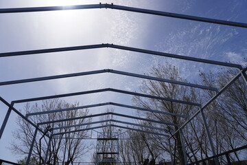 Installation of metal structures using a crane
  against the blue sky