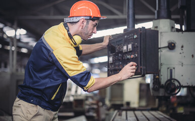 Technician adjusts and troubleshoots factory machinery for optimal performance and safety standard