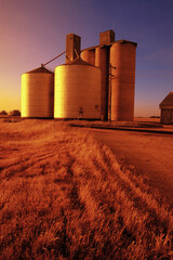 grain silos at sunset
