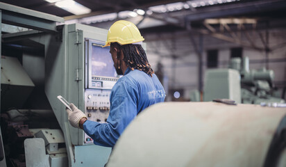 Technician adjusts and troubleshoots factory machinery for optimal performance and safety standard