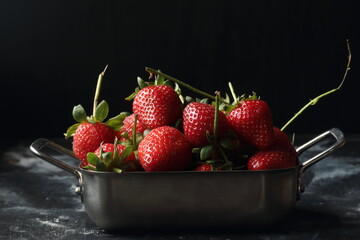 Strawberry fruits on a black background