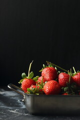 Strawberry fruits on a black background