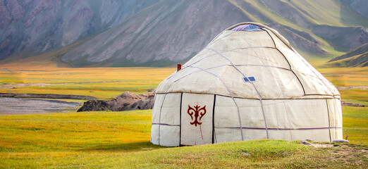 Yurt. National old house of the peoples of Kyrgyzstan and Asian countries. national housing. Yurts on the background of green meadows and highlands. Yurt camp for tourists.