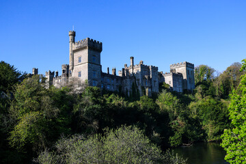 Fototapeta na wymiar Lismore Castle, County Waterford, Ireland, on a tranquil spring day under a flawless blue sky
