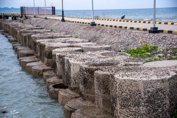 Breakwater rock at Anyer Beach. Breakwater rock is an offshore structure protecting a harbor or...