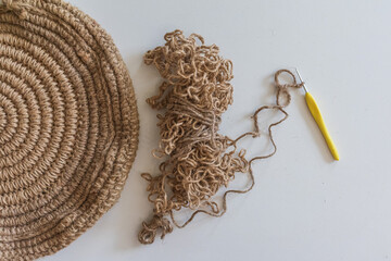 Round knitted bag made of twine, thread and 2mm hook for knitting on a white background