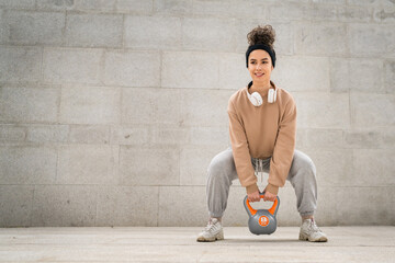 One woman young adult caucasian female hold kettlebell girya weight