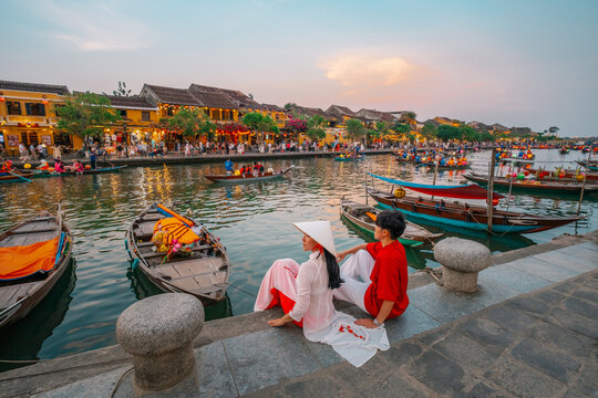 Asian Couple wearing vietnam  traditional culture  walking around at Hoi An ancient town,Hoi an city in Vietnam. - Powered by Adobe