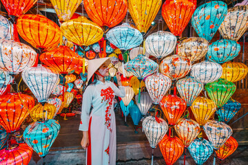 Asian woman wearing vietnam  traditional culture  choosing lanterns  at Hoi An ancient town,Hoi an...